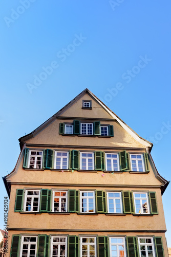 Traditional Yellow Gabled House with Green Shutters in Tubingen Old Town