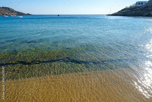 Amazing turquoise and see trough waters at the Mylopotas beach in Ios Greece