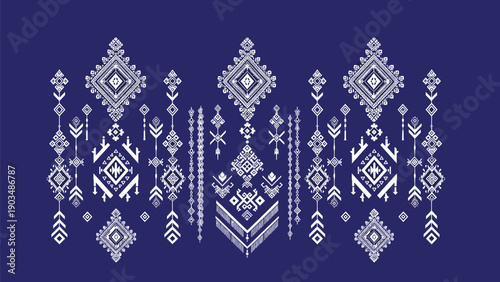 Traditional geometric ethnic pattern with intricate white embroidery details on a solid dark blue background for textile design.