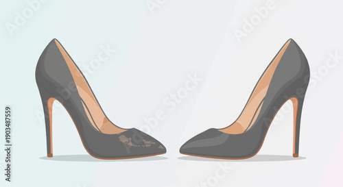 Two grey, high-heeled, pointed-toe shoes are placed on a light background