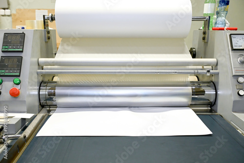 Photos Work behind the laminator in the production shop of the printing house