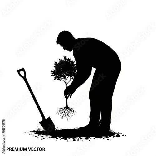Man planting a shrub with a shovel in a garden from a side view