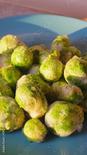 Frozen Brussels sprouts with visible frost texture. Healthy plant-based ingredient for balanced diet, vegetarian and vegan meals, and clean eating concepts.