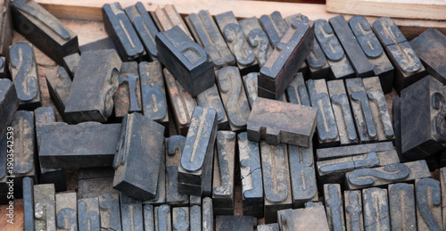 Old rusty English alphabet   letterpress and numbers printing blocks at flea market in Paris, France. Vintage background.