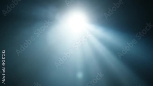 Bright light shining through darkness in stages. Bright light source emerging and expanding with lens flare effect.