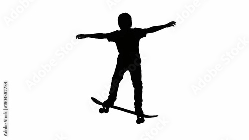 Silhouette of a young person skateboarding with arms outstretched.