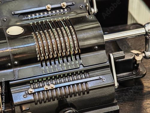 Obraz na płótnie Vintage mechanical calculator and adding machine closeup, black metal counting d