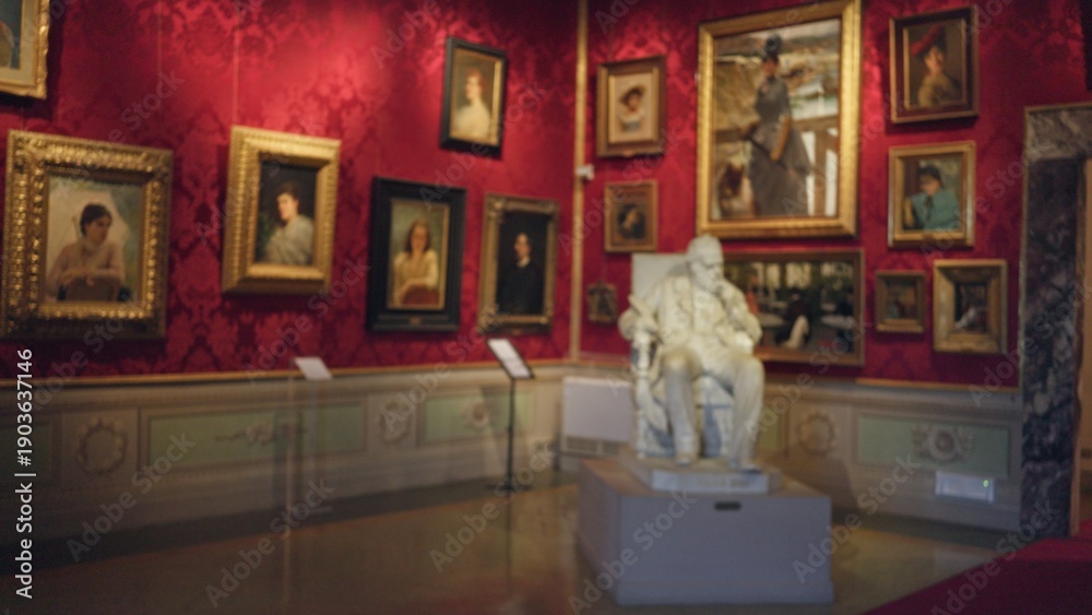 Fototapeta premium Museum gallery interior with defocused bokeh on framed paintings and central statue; background backdrop copyspace calm.