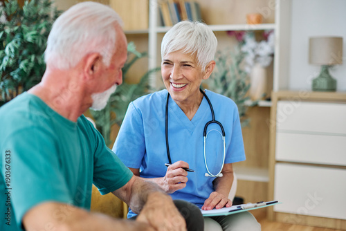 Wallpaper Mural Portrait of a senior doctor or nurse caregiver talking consultation with senior man at home or nursing home Torontodigital.ca