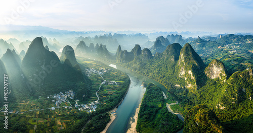 Fotografie Breathtaking aerial view of the Li River winding through karst mountains and rural villages in Guilin, China during a misty morning