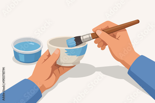 Hands painting ceramic bowl with blue color, enjoying creative pottery craft hobby