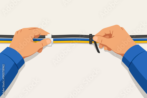 Hands organizing electrical cables with zip ties, creating tidy cable management
