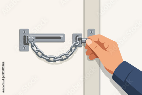 Hand unlocking security chain lock on door