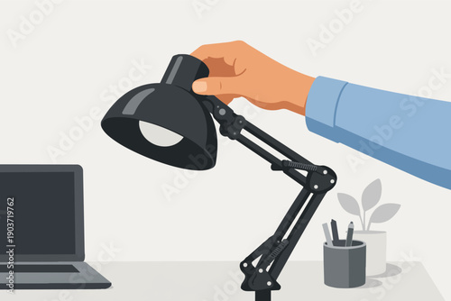 Hand adjusting black desk lamp light over workspace for better illumination
