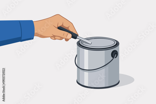 Hand using tool opening metal paint can for home improvement or renovation work