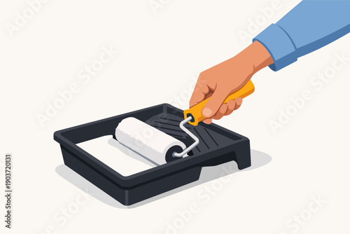 Hand using a paint roller with white paint in tray, renovation and home improvement