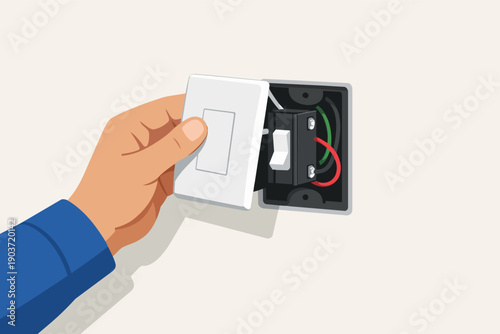 Hand installing light switch cover plate on wall, showing electrical wiring