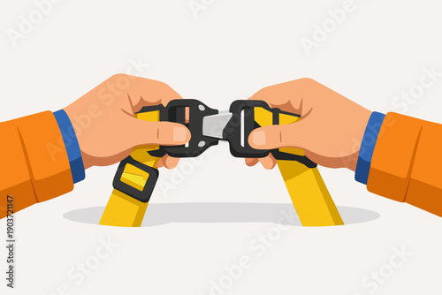 Hands buckling a yellow safety harness, concept of protection and security