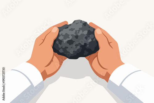 Hands holding a piece of raw coal, symbolizing fossil fuel energy and industry