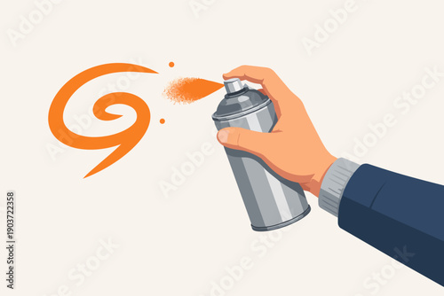 Hand holding spray can creating graffiti art on wall using orange aerosol paint