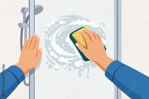 Hands scrubbing a shower glass door with sponge and soap foam during bathroom cleaning
