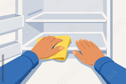 Person cleaning inside a clean refrigerator with a cloth, maintaining hygiene