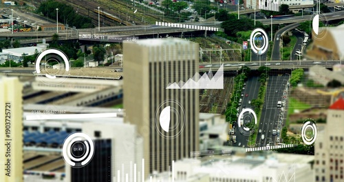Rising tall beige office tower anchoring downtown, showing roads, ramps, rail tracks, vehicles, HUD