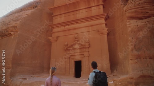 Visiting Hegra in AlUla, tourists explore ancient tombs in Saudi Arabia. Discovering Arabic culture