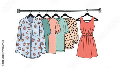 Wardrobe selection of casual clothing including a patterned shirt, t-shirts, and a coral dress hangs neatly on a metal garment rack.