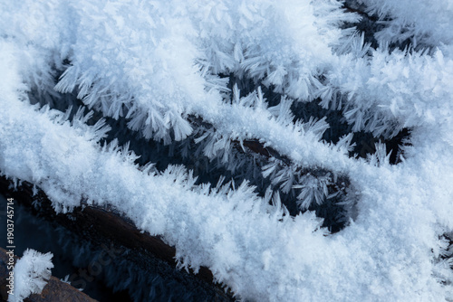 Iron sewer grate with ice crystals from high humidity