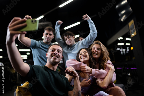 Friends take a selfie at a fitness center during a group workout session enjoying exercise and each others company