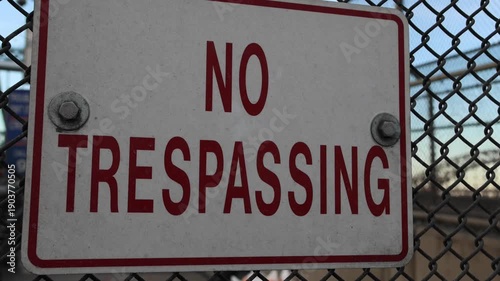 no trespassing sign on bridge infrastructure fence transportation danger private property red warning not to trespass sunset new york city queens prohibited no entry keep out away from high voltage