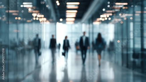 Blurred Corridor: Silhouetted figures of professionals traverse a sleek, modern corridor, conveying a sense of purpose and the flow of daily business life.