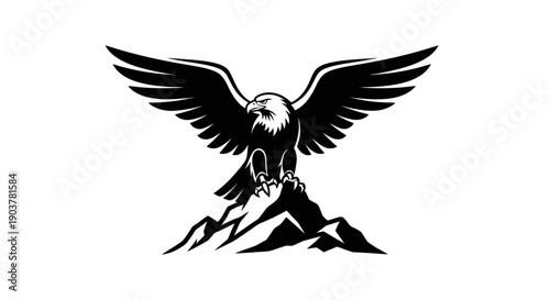 Eagle spreading wings on mountain peak