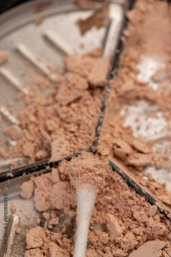 Fototapeta premium old scattered broken cosmetics, makeup powder , dust and small and large pieces of women's cosmetics that were broken