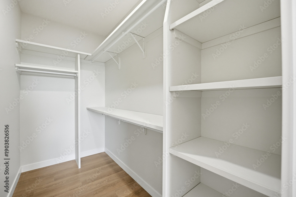 Fototapeta premium White closet with shelves and a wooden floor