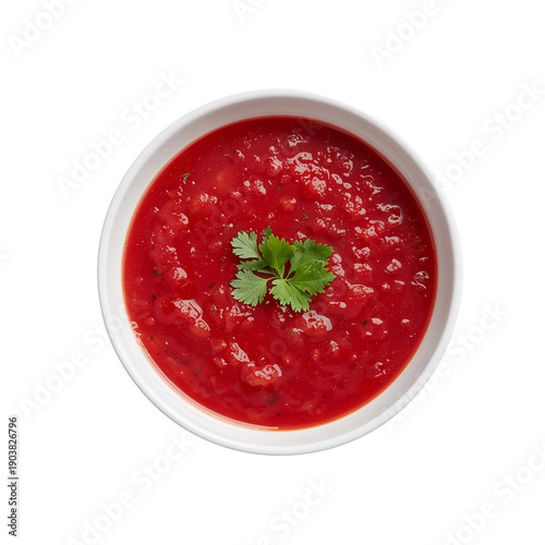 Bowl of Red Soup With Herbs Placed on a White Background in a Kitchen Setting