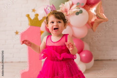 Baby girl  at first birthday with smash cake