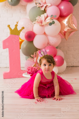Baby girl  at first birthday with smash cake