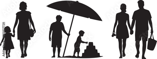 Family walking on beach with sandcastle and umbrella