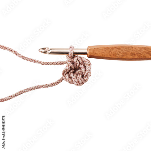 Crochet Hook With Yarn Loop on Wooden Surface During Crafting Session