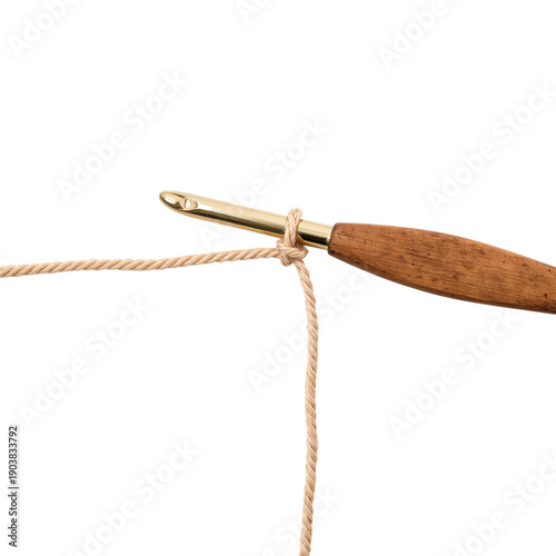 Crochet Hook With Yarn Loop on Wooden Surface During Crafting Session