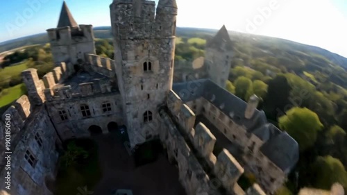 An eye-level shot captures a medieval castle and a lush green landscape at daytime.  FPV drone perspective landscape animation