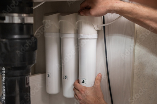 The technician changes water filters.