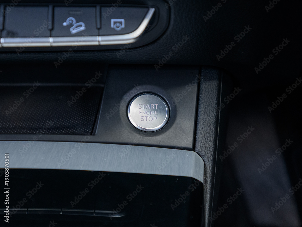 Naklejka premium Car engine start stop button on modern vehicle dashboard