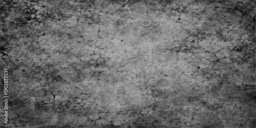 A dark and aged grey concrete surface features a rough vintage grunge wall texture with a dirty textured pattern design, creating a black weathered stone backdrop for a gritty material wallpaper