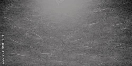 A dark grunge texture of an old black chalk board featuring a rough grey paper pattern and vintage metal frame on a dirty wall surface backdrop