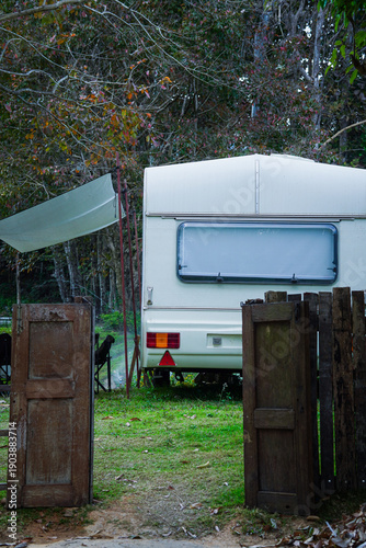 Vintage Camper Entrance with Wooden Doors and Awning