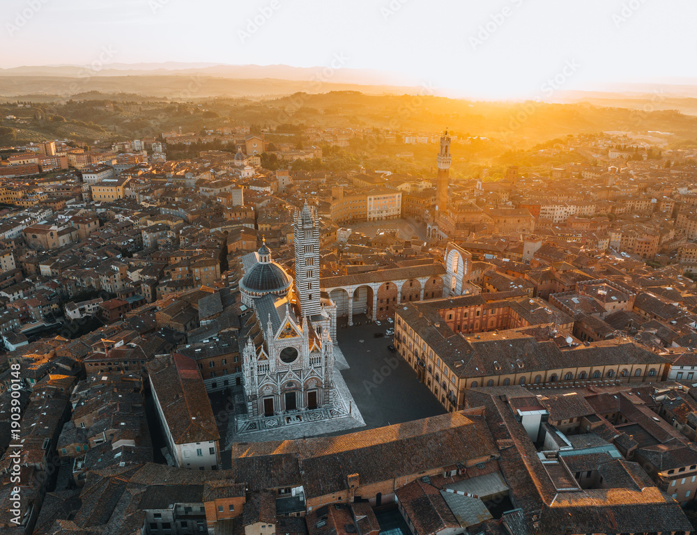 Fototapeta premium Aerial view of Siena Cathedral and historic city center at sunset, Tuscany, Italy