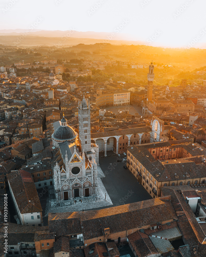 Fototapeta premium Aerial view of Siena Cathedral and historic city center at sunset, Tuscany, Italy
